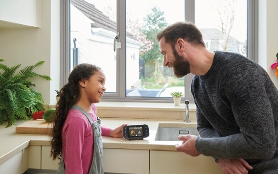 father and daughter looking at smart meter reading 